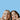 A blond girl and brunette girl smiling at the camera and giving two thumbs up