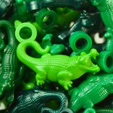 Vibrant assortment of plastic alligator tokens in various shades of green, including forest pearl, dark green, lime green, and classic green, perfect for classroom incentives and rewards.