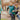 Two young boys running outside on a playground